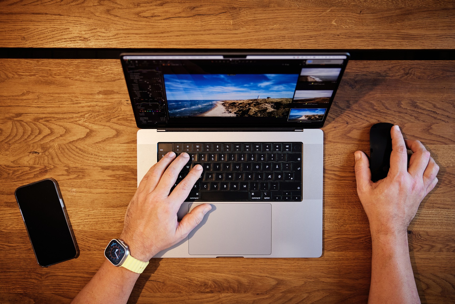 Cropped hands of man using laptop on table